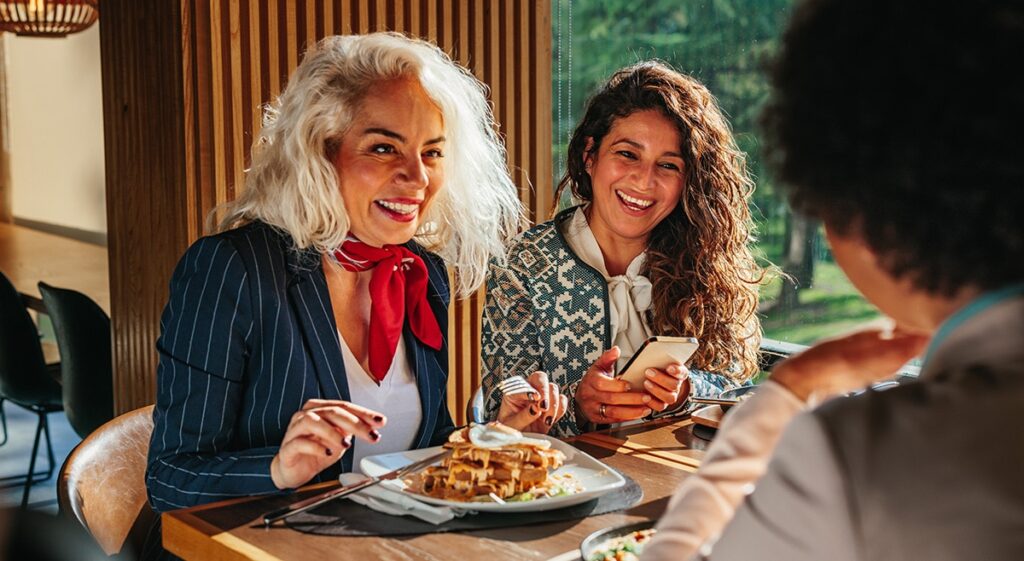 middle aged woman eating steak