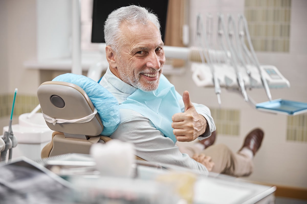 senior man with dental implants